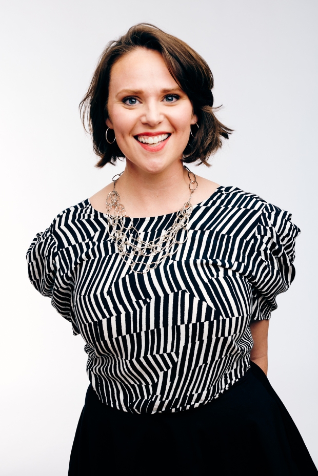Entrepreneur Carly Buxton, wearing black and white stripes and a silver necklace, smiles openly
